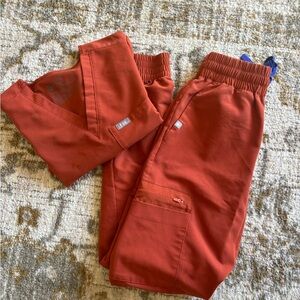 Figs scrubs in auburn orange